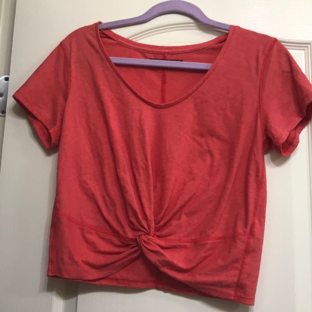 A knotted coral cropped shirt